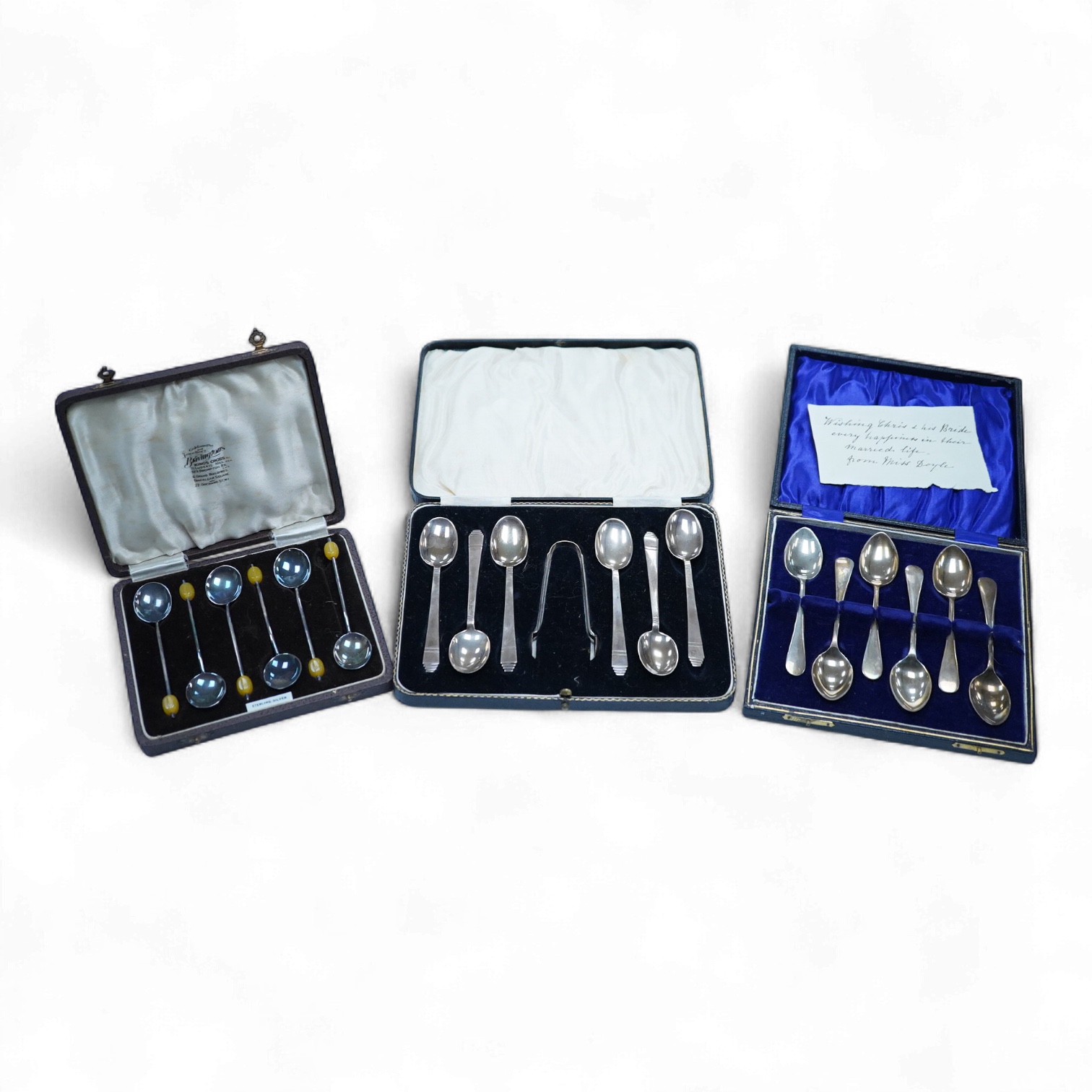 A cased set of six George VI Art Deco silver teaspoons and pair of sugar tongs, by C.W. Fletcher & Son Ltd, Sheffield, 1936, together with a cased set of six silver bean end coffee spoons and a cased set of six plated te